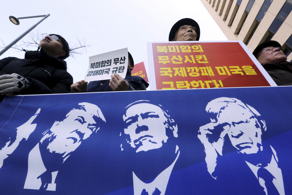 Protesters hold a banner showing images, from left, of U.S. President Donald Trump, Secretary of State Mike Pompeo and National Security Adviser John Bolton during a rally against the United States' policy to put steady pressure on North Korea, near the U.S. Embassy in Seoul, South Korea, Friday, March 22, 2019. The Trump administration on Thursday sanctioned two Chinese shipping companies suspected of helping North Korea evade sanctions, the first targeted actions taken against Pyongyang since its nuclear negotiations with the U.S. in Hanoi last month ended without agreement. The signs read: "We denounce the United States." (AP Photo/Ahn Young-joon)