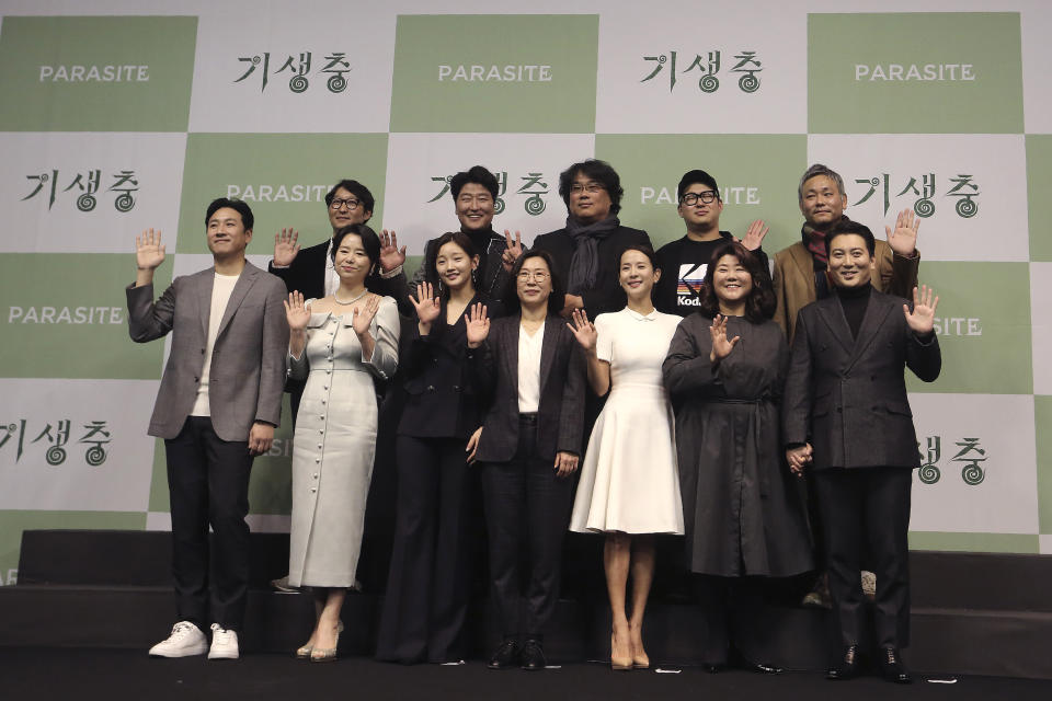 Bong Joon-ho, director of Oscar-winning “Parasite,” rear center, poses with the cast and crew after a press conference in Seoul, South Korea, Wednesday, Feb. 19, 2020. Bong said Wednesday “the biggest pleasure and the most significant meaning” that the film has brought to him was its success in many countries though the audiences might feel uncomfortable with his explicit description of a bitter wealth disparity in modern society. (AP Photo/Ahn Young-joon)