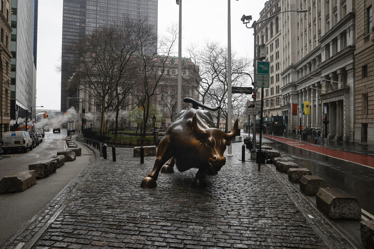 The Wall St. Bull is seen standing on a nearly empty Broadway in the financial district, as the coronavirus disease (COVID-19) outbreak continues, in New York City, New York, U.S., March 23, 2020. REUTERS/Mike Segar