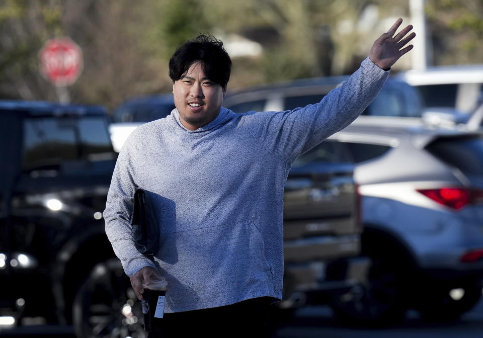 Toronto Blue Jays starting pitcher Hyun Jin Ryu waves to teammates as he arrives during baseball spring training in Dunedin, Fla., on Monday, Feb. 13, 2023. (Nathan Denette/The Canadian Press via AP)