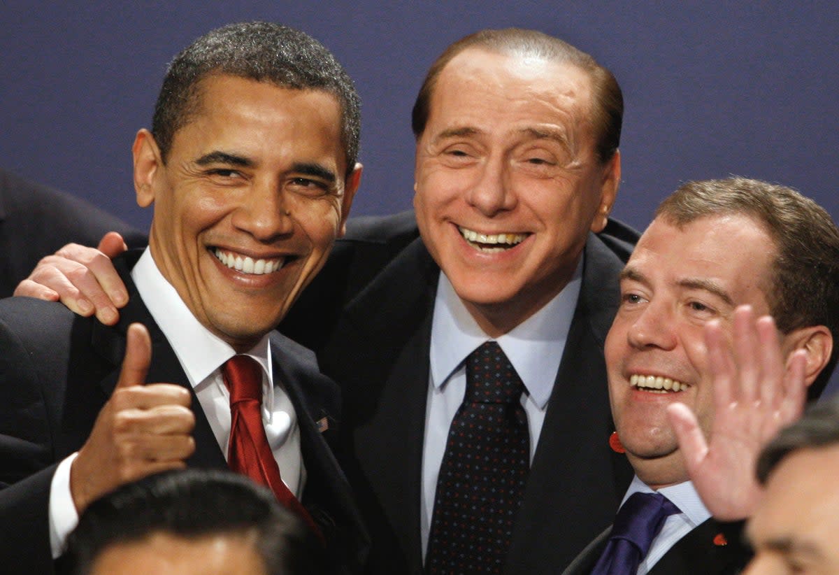 Barack Obama, Berlusconi and Russian president Dmitry Medvedev smile in a group photo at the G20 summit in London (AP)