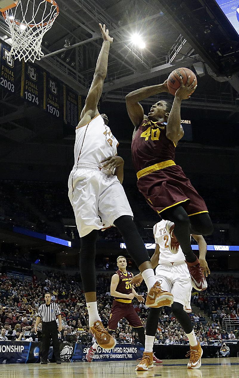 Arizona State guard Shaquielle McKissic (40) goes up for a shot against Texas center Prince Ibeh (44) during the first half of a second round NCAA college basketball tournament game Thursday, March 20, 2014, in Milwaukee. (AP Photo/Morry Gash)