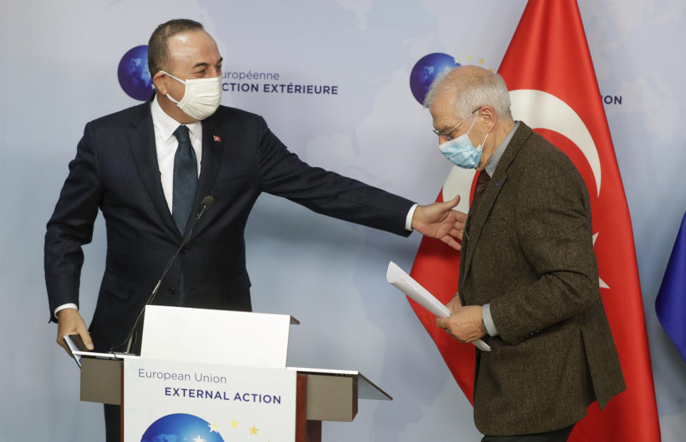 Turkey's Foreign Minister Mevlut Cavusoglu, left, and European Union foreign policy chief Josep Borrell leave after giving a joint statement prior to their meeting in Brussels, Thursday, Jan. 21, 2021. (Stephanie Lecocq/Pool Photo via AP)