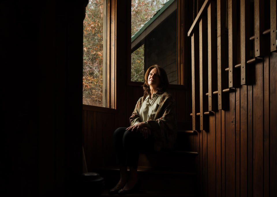 Linda Clary sits on the stairs in her home (Will Crooks for NBC News)