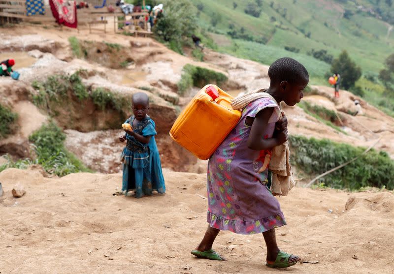 FILE PHOTO: A girl carries a container of water at a coltan mine in Kamatare, Masisi territory, North Kivu Province of Democratic Republic of Congo