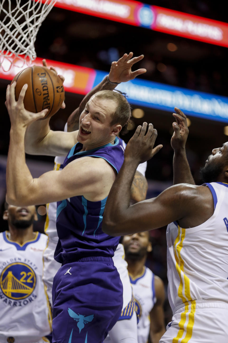 Charlotte Hornets forward Cody Zeller pulls down an offensive rebound during the first half of the team's NBA basketball game against the Golden State Warriors in Charlotte, N.C., Wednesday, Dec. 4, 2019. (AP Photo/Nell Redmond)