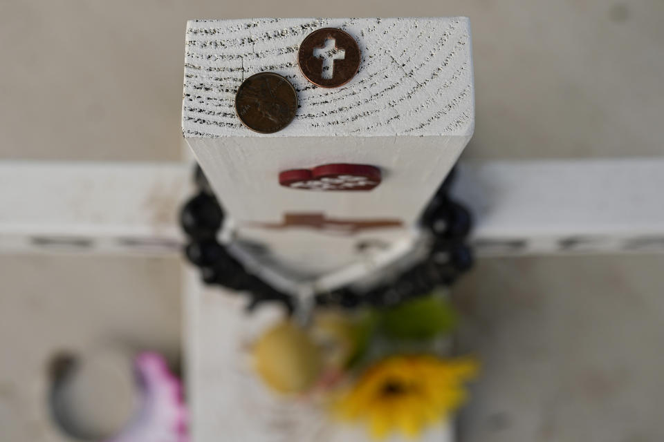 A decorated cross at Robb Elementary School to honor Tess Mata stands at the boarded up campus in Uvalde, Texas, Wednesday, May 3, 2023. (AP Photo/Eric Gay)
