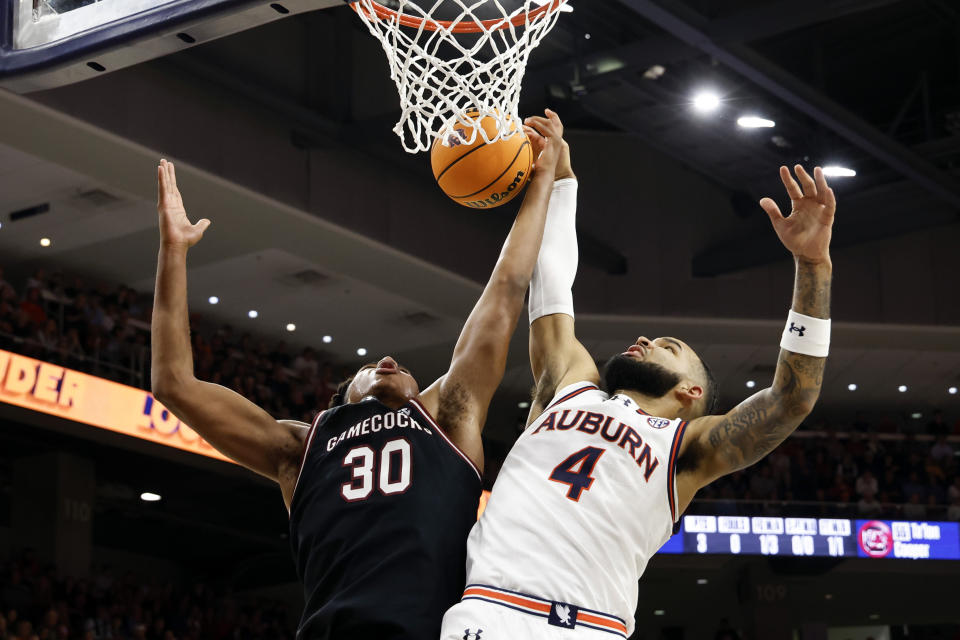 Auburn forward Johni Broome (4) blocks the shot attempt of South Carolina forward Collin Murray-Boyles (30) during the first half of an NCAA college basketball game Wednesday, Feb. 14, 2024, in Auburn, Ala. (AP Photo/Butch Dill)