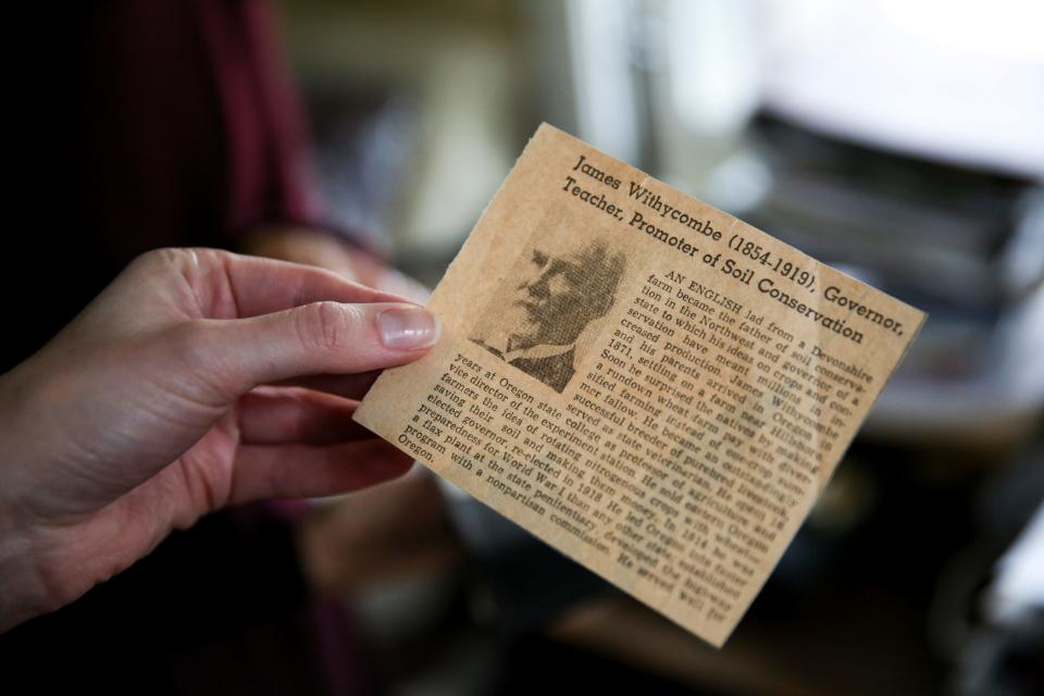 Statesman Journal reporter Claire Withycombe looks at newspaper clippings about her great-great-grandfather Gov. Withycombe on Thursday, Nov. 11, 2021, in Hillsboro, Ore.