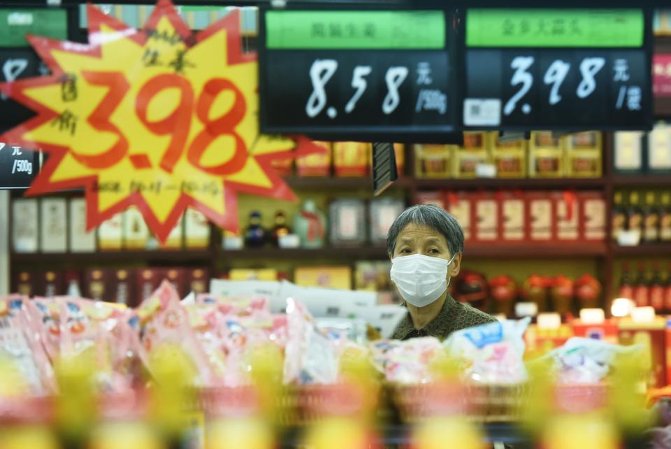 Customers choose vegetables at a supermarket in Hangzhou.