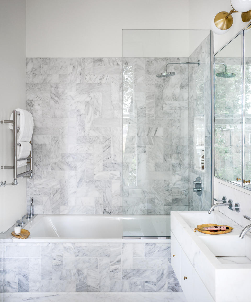 grey tiled bathroom with shower and tub