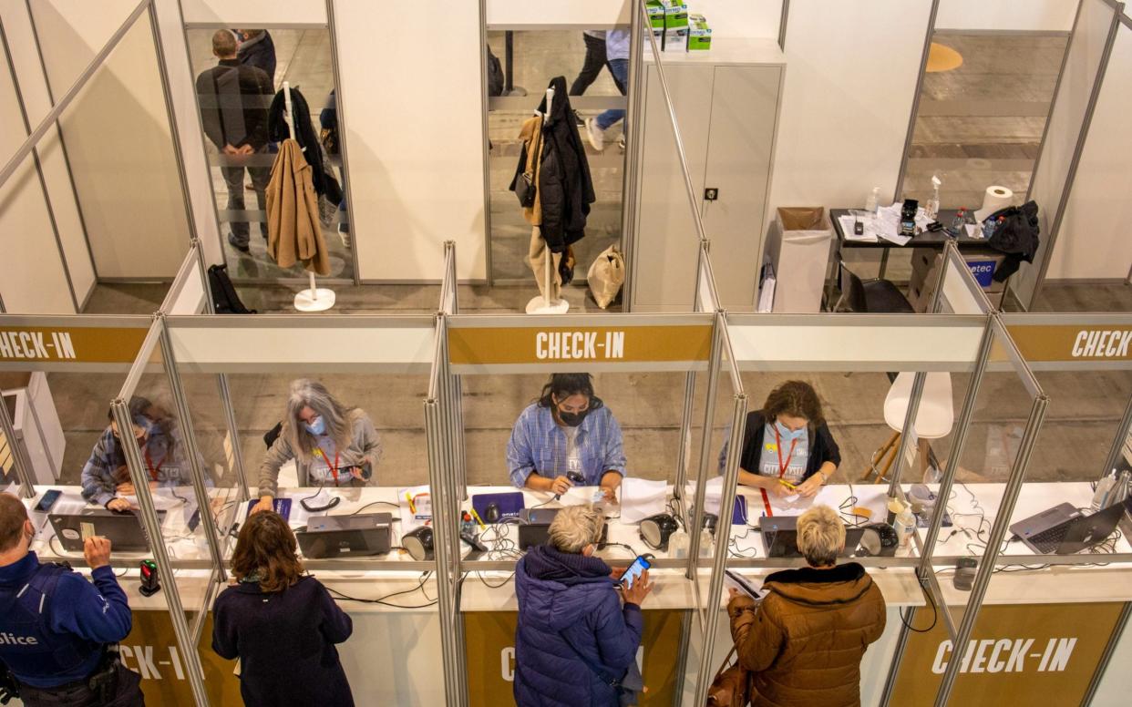 Visitors check-in at the Brussels Expo Covid-19 Vaccination Centre in Brussels, Belgium - Bloomberg