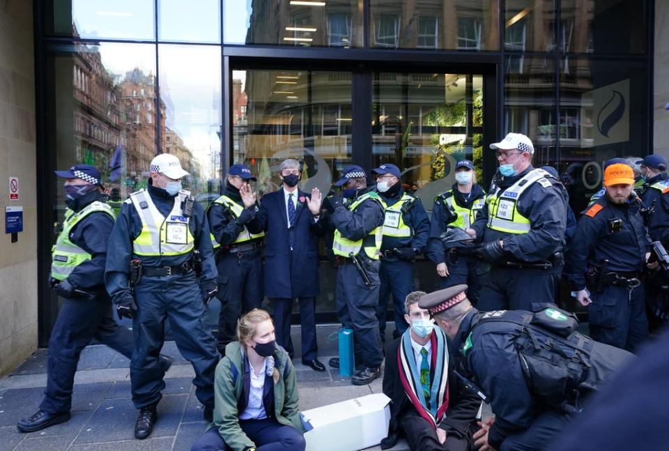 Extinction Rebellion proteststers and police outside SSE (Jane Barlow/PA) (PA Wire)