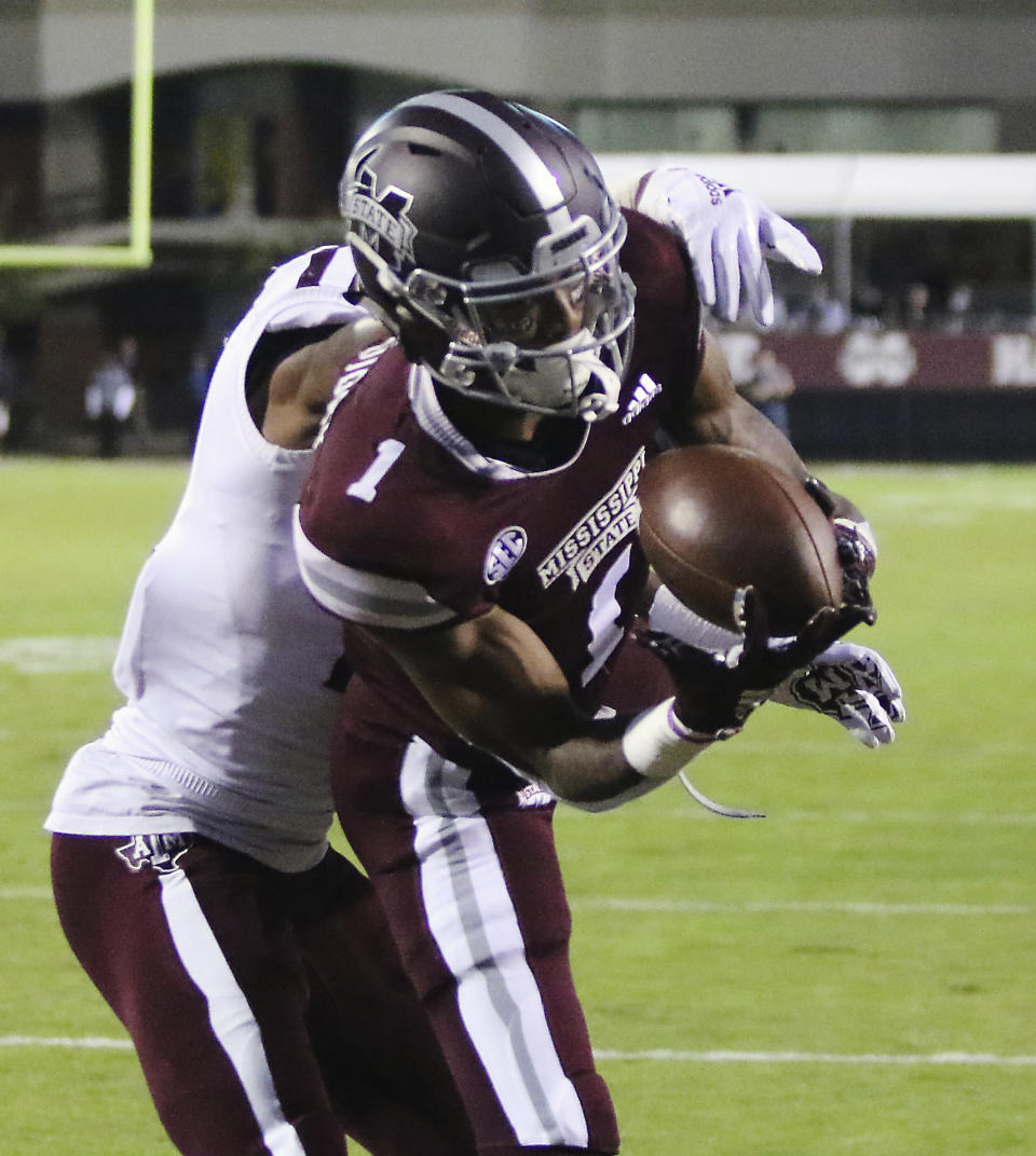 Mississippi State wide receiver Stephen Guidry (1) catches a pass for a touchdown ahead of Texas A&M defensive back Charles Oliver (21) during the first half of their NCAA college football game on Saturday, Oct. 27, 2018, in Starkville, Miss. (AP Photo/Jim Lytle)