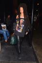 <p>In a leather jacket, off-the-shoulder Tupac t-shirt, leather leggings, black Fenty x Puma creepers, Louis Vuitton box bag, green leather tote and Moschino phone case in NYC.</p>