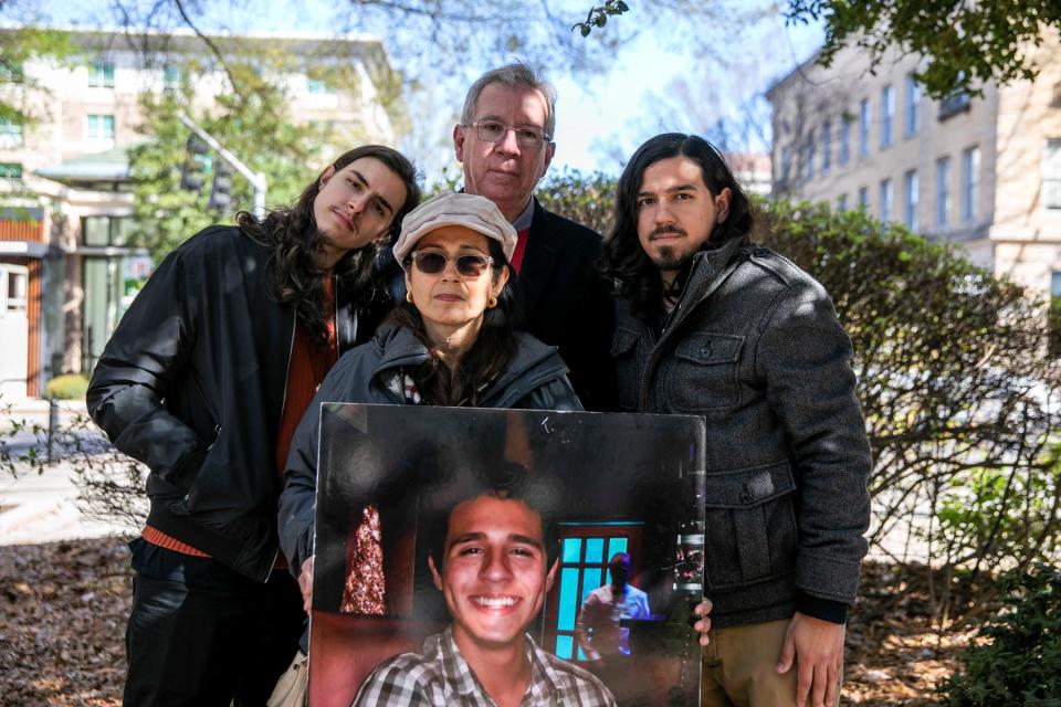 Mother, Belkis Teran, father, Joel Paez and brothers, Daniel Paez and Pedro Teran, of environmental activist Manuel Paez Teran, who was killed by law enforcement during a raid to clear the construction site of a public safety training facility, stand for a portrait with a photo of Manuel following a news conference with their attorneys held outside of the Historic DeKalb Courthouse in Decatur, Georgia, U.S., March 13, 2023.  An independent autopsy requested by the family states that Manuel's hands were raised when law enforcement shot him. The family has field a lawsuit against the City of Atlanta under the Georgia Open Records Act to learn more information about Manuel's death. REUTERS/Alyssa Pointer - RC21TZ99KMNU