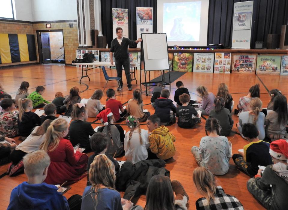 Part of Christmas week events at Conesville Elementary School this past week was a visit from children's book illustrator and author Richard Cowdrey of Mount Vernon. He had a slideshow on his life and artwork and taught students how to draw his signature character, Fiona the hippo.