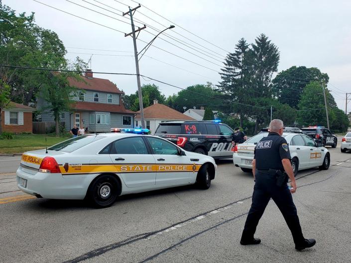 Police deploy after gunfire erupted at a Fourth of July parade route in the wealthy Chicago suburb of Highland Park, Illinois, U.S. July 4, 2022