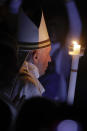 Pope Francis holds a candle as he presides over a solemn Easter vigil ceremony in St. Peter's Basilica at the Vatican, Saturday, April 21, 2019. (AP Photo/Gregorio Borgia)