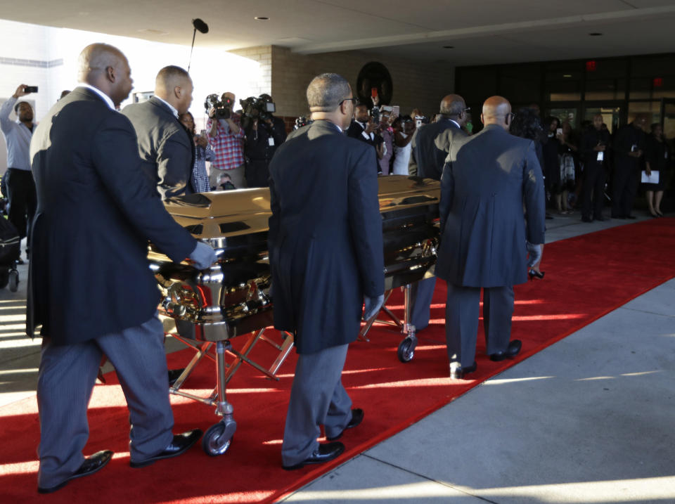 Pallbearers carry the gold casket of legendary singer Aretha Franklin after arriving at the Greater Grace Temple in Detroit, Friday, Aug. 31, 2018. Franklin died Aug. 16 of pancreatic cancer at the age of 76. (AP Photo/Tony Dejak)