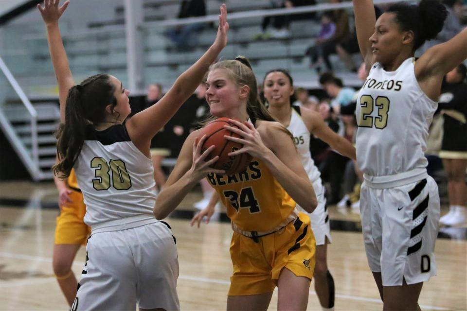 Monroe Central girls basketball's Kimber Abshear controls a rebound in her team's game at Daleville High School on Tuesday, Nov. 8, 2022.