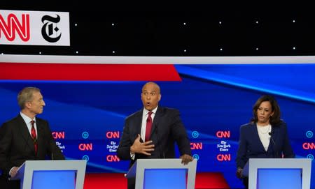 Democratic presidential candidate Senator Cory Booker speaks as billionaire activist Tom Steyer and Senator Kamala Harris listen during the fourth U.S. Democratic presidential candidates 2020 election debate in Westerville, Ohio