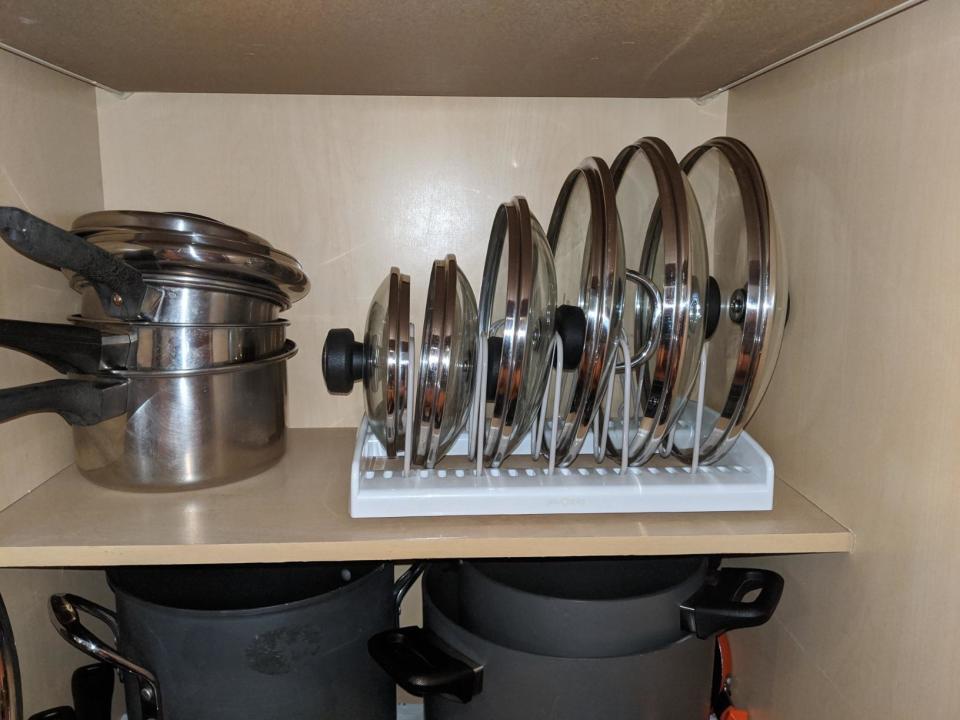 reviewer photo showing lids to pots and pans neatly organized in the bakeware rack