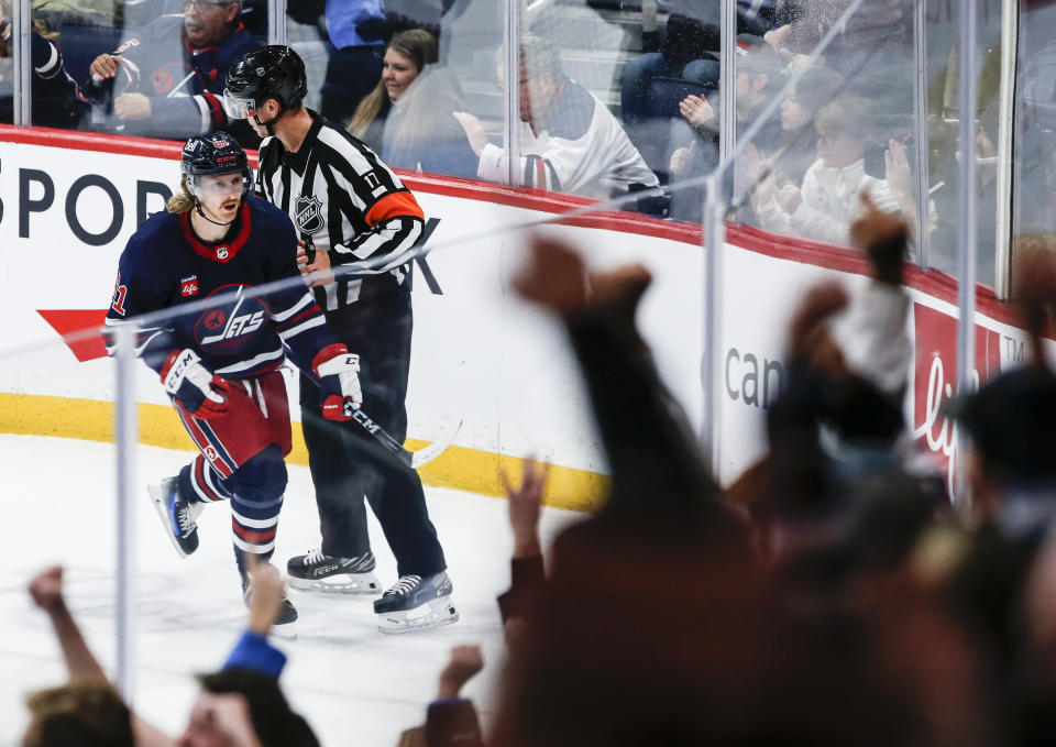 Winnipeg Jets' Kyle Connor (81) celebrates his goal against the Arizona Coyotes during the second period of an NHL hockey game, Saturday, Nov. 18, 2023 in Winnipeg, Manitoba. (John Woods/The Canadian Press via AP)