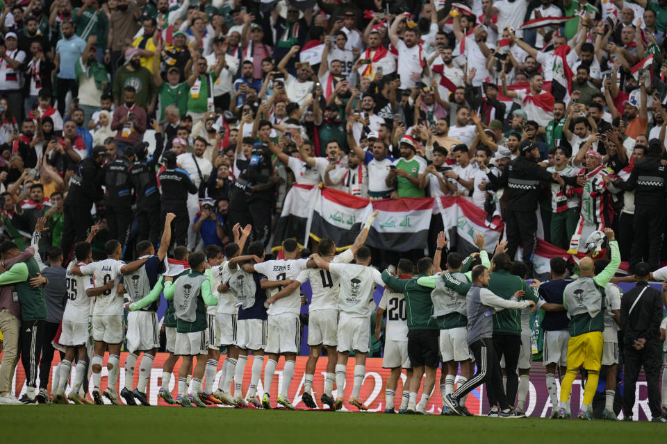 Iraqi players celebrate after the Asian Cup Group C soccer match between Iraq and Japan at the Education City Stadium in Al Rayyan, Qatar, Friday, Jan. 19, 2024. Iraq won 2-1. (AP Photo/Aijaz Rahi)