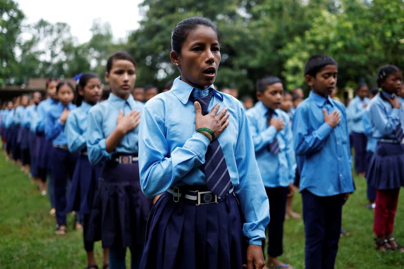 The Wider Image: Nepali woman's quest to learn takes her back to school with son