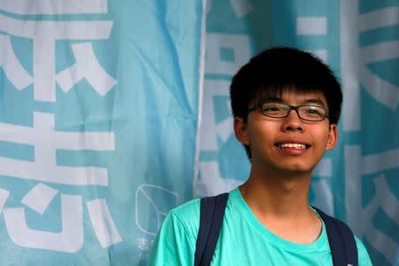 Student leader Joshua Wong smiles outside a court before a verdict, on charges of inciting and participating in an illegal assembly in 2014 which led to the "Occupy Central" pro-democracy movement, in Hong Kong August 15, 2016. REUTERS/Bobby Yip