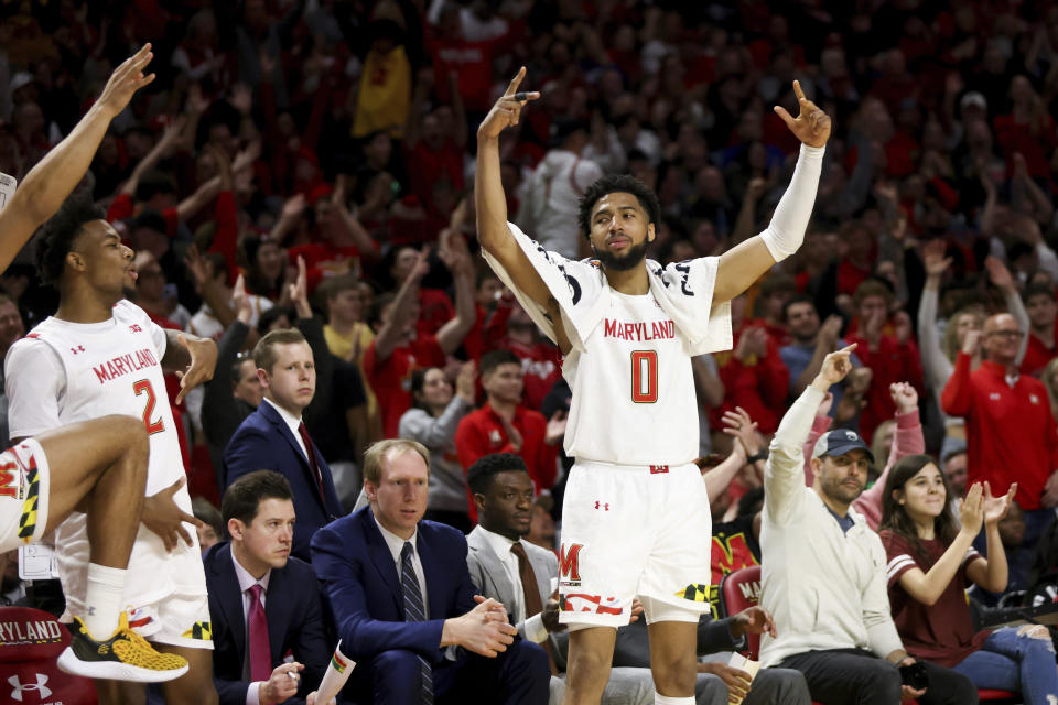 Maryland guard Don Carey (0) and the bench react during the second half of an NCAA college basketball game against Northwestern, Sunday, Feb. 26, 2023, in College Park, Md. Maryland won 75-59. (AP Photo/Julia Nikhinson)