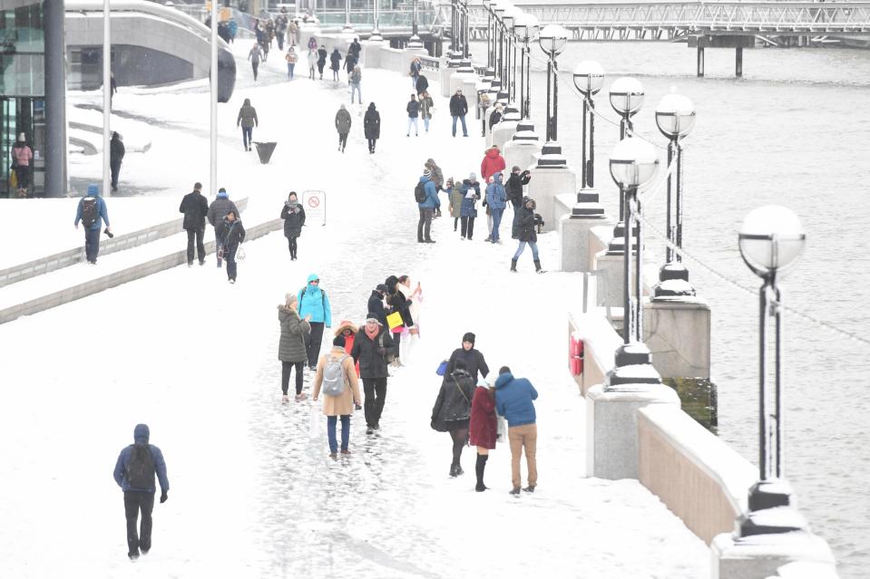 People walking in the snow by Tower Bridge in London in February (Victoria Jones/PA)