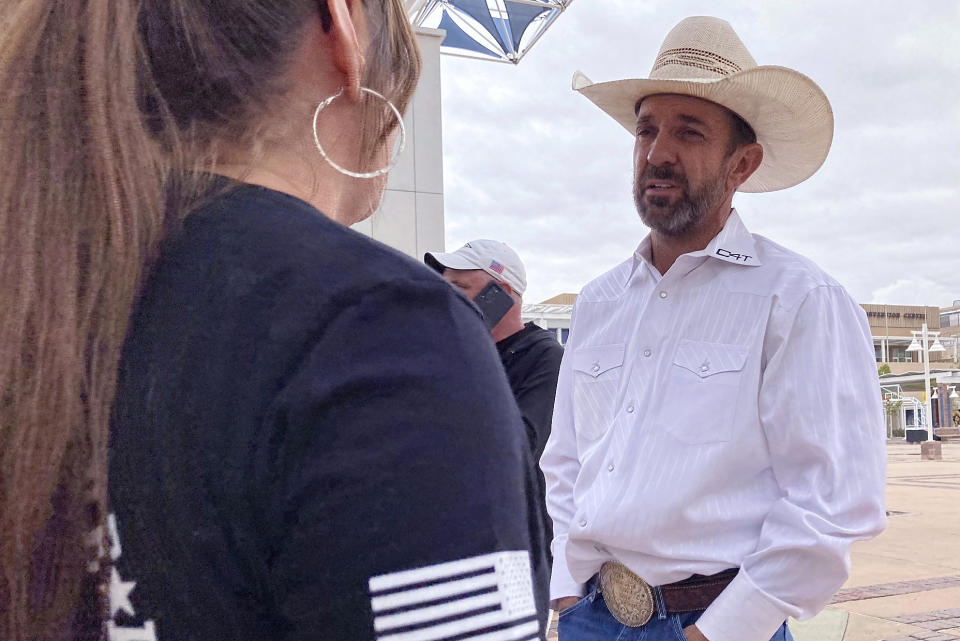 Couy Griffin talks with a supporter during a rally, Tuesday, Sept. 12, 2023 in Albuquerque, N.M. Griffin traveled from Alamogordo, NM, to support those protesting New Mexico Gov. Michelle Lujan Grisham's order on Friday suspending the open and concealed carry of guns in most public places. (AP Photo/Susan Montoya Bryan)