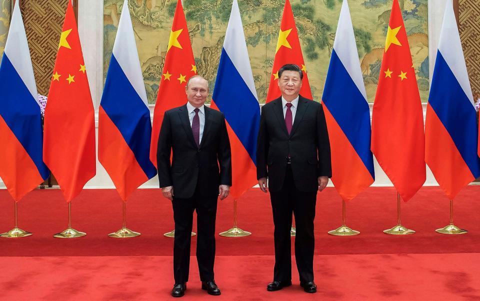  In this photo provided by China's Xinhua News Agency, Chinese President Xi Jinping, right, pose for photos with Russian President Vladimir Putin at the Diaoyutai State Guesthouse in Beijing, China, on Feb. 4, 2022 - Li Tao/ Xinhua