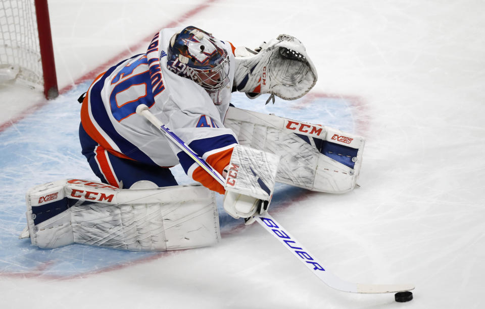 New York Islanders goaltender Semyon Varlamov uses his stick to collect the puck after stopping a shot against the Colorado Avalanche in the first period of an NHL hockey game Wednesday, Feb. 19, 2020, in Denver. (AP Photo/David Zalubowski)