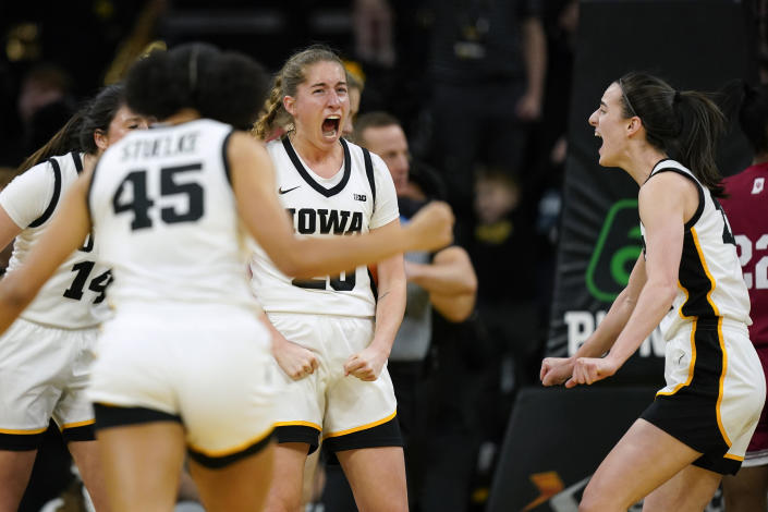 Iowa guard Kate Martin, center, celebrates with teammates after making a basket during the first half of an NCAA college basketball game against Indiana, Sunday, Feb. 26, 2023, in Iowa City, Iowa. (AP Photo/Charlie Neibergall)