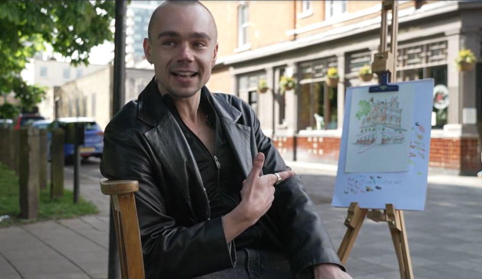 London-born artist   Chris Lloyd, a self-described Swiftie, points to his new drawing of The Black Dog pub, in the British capital, as he speaks with CBS News outside the establishment, April 24, 2024. / Credit: CBS News/Duarte Dias