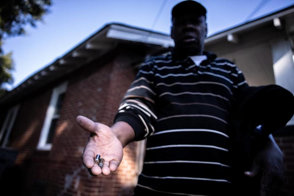 Frank Byers, former head of the Greater Enderly Park Neighborhood Association, holds out bullet casings found outside of his apartment in Charlotte, N.C., on Monday, October 18, 2021.