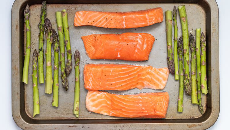 A photograph of salmon with asparagus. 