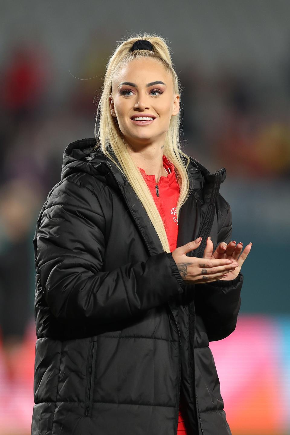 AUCKLAND, NEW ZEALAND - AUGUST 05: Alisha Lehmann of Switzerland applauds fans after the team's 1-5 defeat and elimination from the tournament following the FIFA Women's World Cup Australia & New Zealand 2023 Round of 16 match between Switzerland and Spain at Eden Park on August 05, 2023 in Auckland, New Zealand. (Photo by Phil Walter/Getty Images)