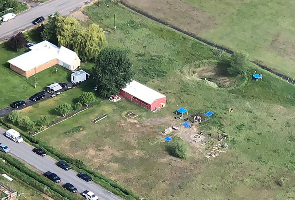 CORRECTS LOCATION TO SALEM, IDAHO, INSTEAD OF REXBURG This aerial photo provided by East Idaho News shows authorities investigating a home in Salem, Idaho, on Tuesday June 9, 2020. Authorities say they uncovered human remains at an Idaho man's home as they investigated the disappearance of his new wife's two children. The case has drawn global attention for its ties to the couple's doomsday beliefs and the mysterious deaths of their former spouses. Police in the small town say Chad Daybell was taken into custody. (Nate Eaton/EastIdahoNews.com via AP)