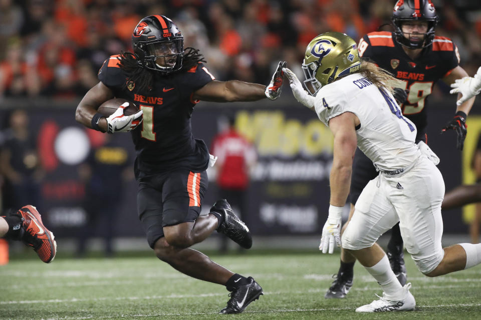 Oregon State running back Deshaun Fenwick (1) defends against UC Davis defensive back Rex Connors (4) during the second half of an NCAA college football game Saturday, Sept. 9, 2023, in Corvallis, Ore. Oregon State won 55-7. (AP Photo/Amanda Loman)