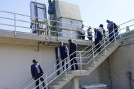 FILE - EPA Administrator Michael Regan, third from left, and Jackson Mayor Chokwe Antar Lumumba, climb down from a section of the Jackson Water Treatment Facility in Ridgeland, Miss., on Nov. 15, 2021. The Environmental Protection Agency is taking a series of enforcement actions to address air pollution, unsafe drinking water and other problems in minority communities in three Gulf Coast states that Administrator Michael Regan visited as part of a "Journey to Justice" tour last fall. (AP Photo/Rogelio V. Solis, File)