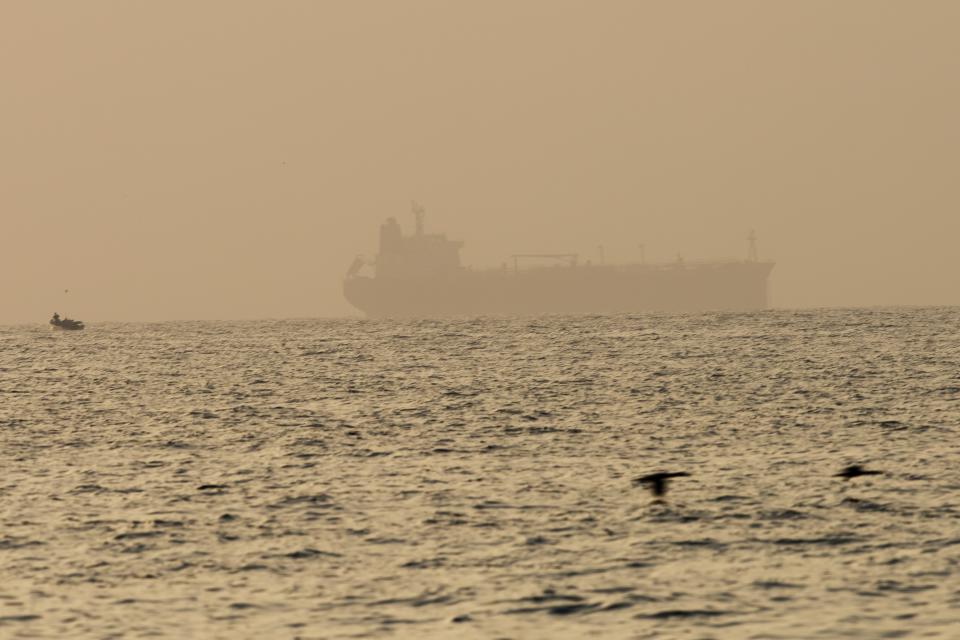 The oil tanker Mercer Street, which came under attack last week off Oman, is seen moored off Fujairah, United Arab Emirates, Wednesday, Aug. 4, 2021. The British navy warned of a "potential hijack" of another ship off the coast of the United Arab Emirates in the Gulf of Oman on Tuesday, though the circumstances remain unclear. (AP Photo/Jon Gambrell)