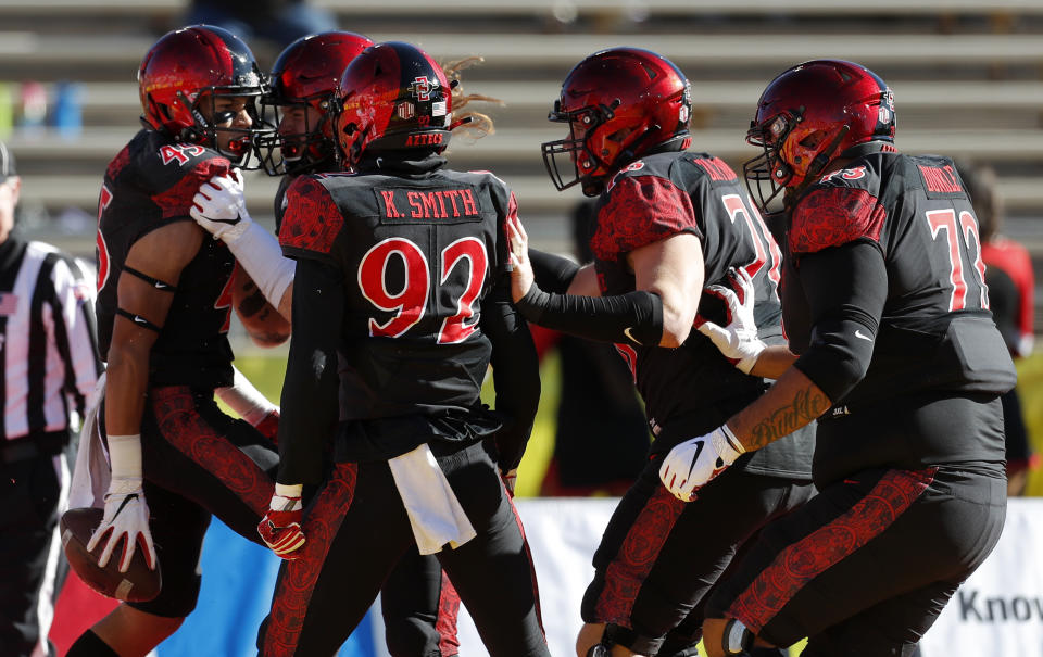San Diego State wide receiver Jesse Matthews, far left, celebrates with teammates after scoring a touchdown during the first half of the New Mexico Bowl NCAA college football game against Central Michigan on Saturday, Dec. 21, 2019 in Albuquerque, N.M. (AP Photo/Andres Leighton)