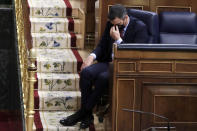 Spain's Prime Minister Pedro Sanchez listens to a speech by Vox party leader Santiago Abascal during a parliamentary session in Madrid, Spain, Wednesday Oct. 21, 2020. Spanish Prime Minister Pedro Sanchez faces a no confidence vote in Parliament put forth by the far right opposition party VOX. (AP Photo/Manu Fernandez, Pool)