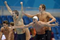 France's Clement Lefert, Amaury Leveaux and Fabien Gilot celebrate after winning the men's 4x100m freestyle relay final swimming event at the London 2012 Olympic Games at the Olympic Park in London