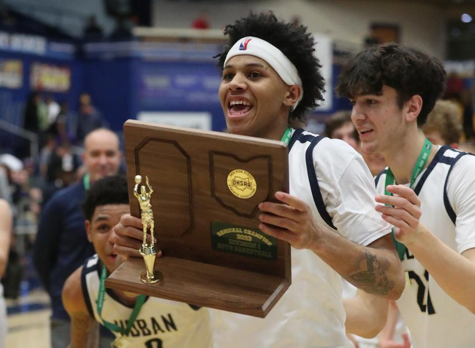 Hoban's William Scott Jr. carries the trophy over to the fans as they celebrate their win over Walsh Jesuit in the Division I regional final, Friday, March 10, 2023, at Kent State.