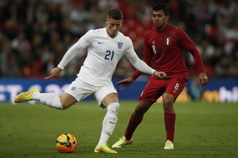 England's midfielder Ross Barkley (L) plays the ball in front of Peru's midfielder Rinaldo Cruzado (R) during a match between England and Peru at Wembley Stadium on May 30, 2014